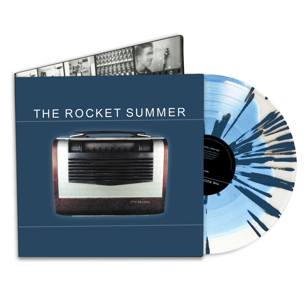 A blue and white splatter vinyl from The Rocket Summer’s 25th anniversary debut LP, remixed by Bryce Avary, is partially slid from a cover showing the band name and a vintage radio, with a visible inner sleeve featuring black-and-white photos.