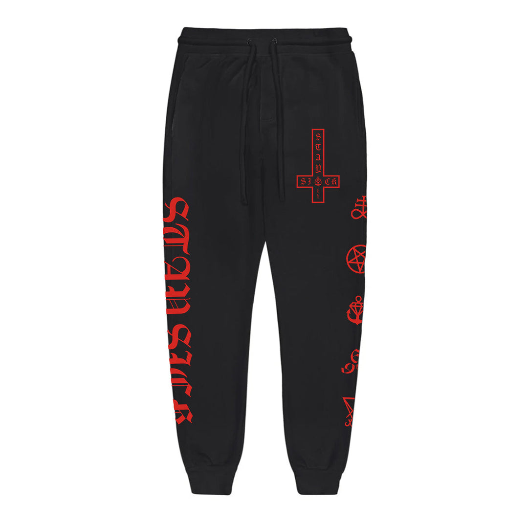 Stay Sick Clothing’s occult-inspired black joggers feature bold red graphics—a large upside-down cross, mystic symbols on one leg, and SATANIC in striking red letters down the other.