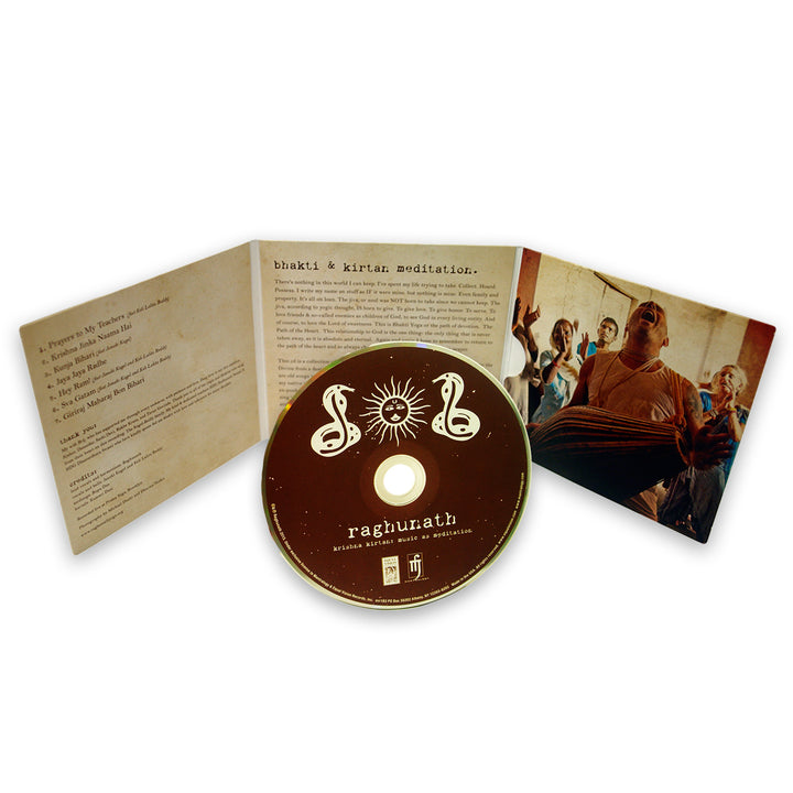 A Raghunath music CD sits before its open case, which shows lyrics or instructions on one side and a photo of people singing Krishna Kirtan on the other, capturing a spiritual, devotional mood themed around Music As Meditation.