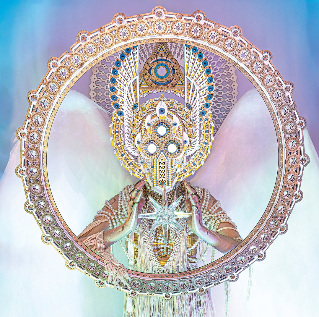 A figure in a geometric costume with angelic wings and vibrant colors holds a star-shaped object, reflecting the mystical energy of Eidola’s Mend CD artwork.