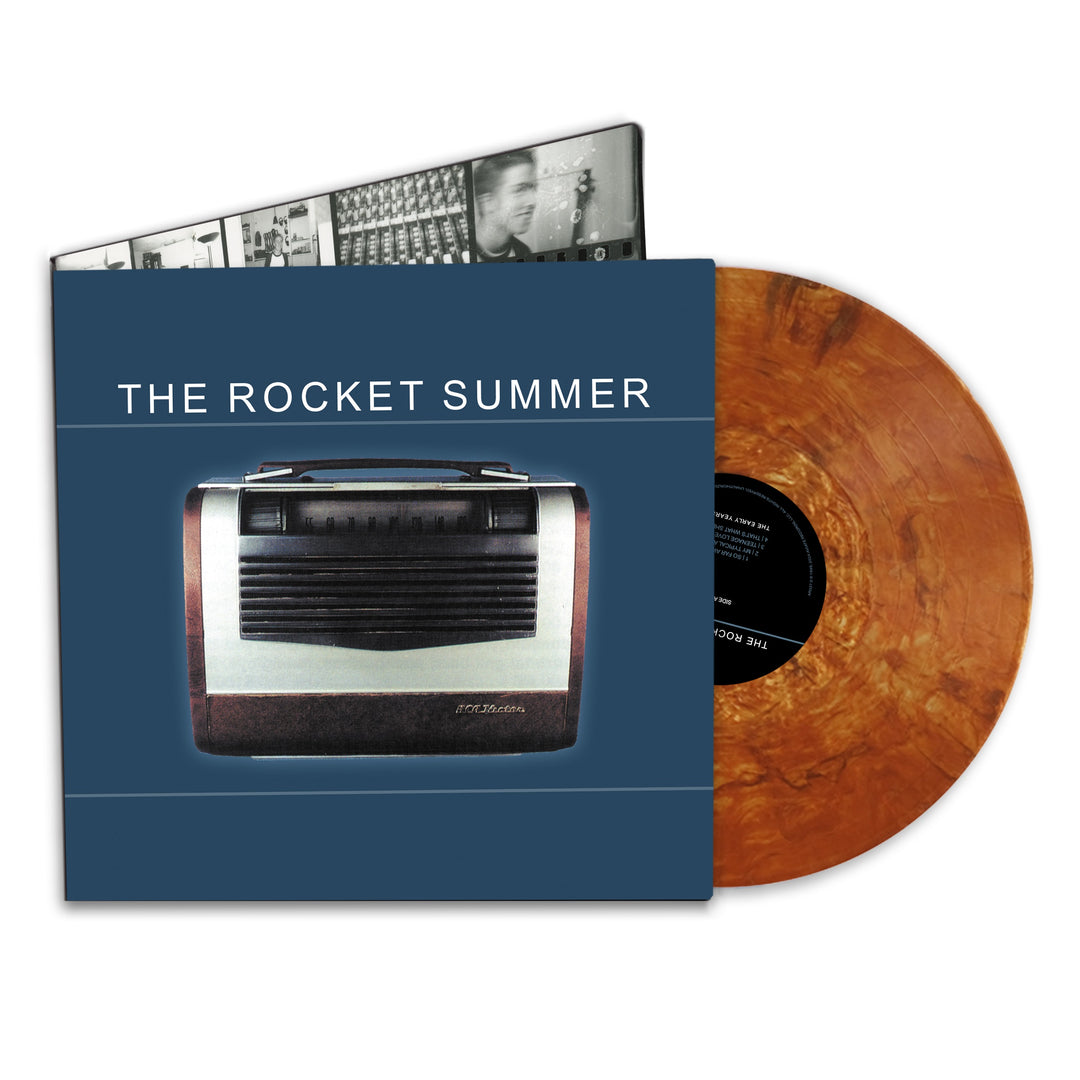 A marbled Copper Nugget Shimmer vinyl from The Rocket Summer partly slides out of a blue album cover with an old radio and THE ROCKET SUMMER text; this 25th anniversary edition also shows a black-and-white inner sleeve with photos.