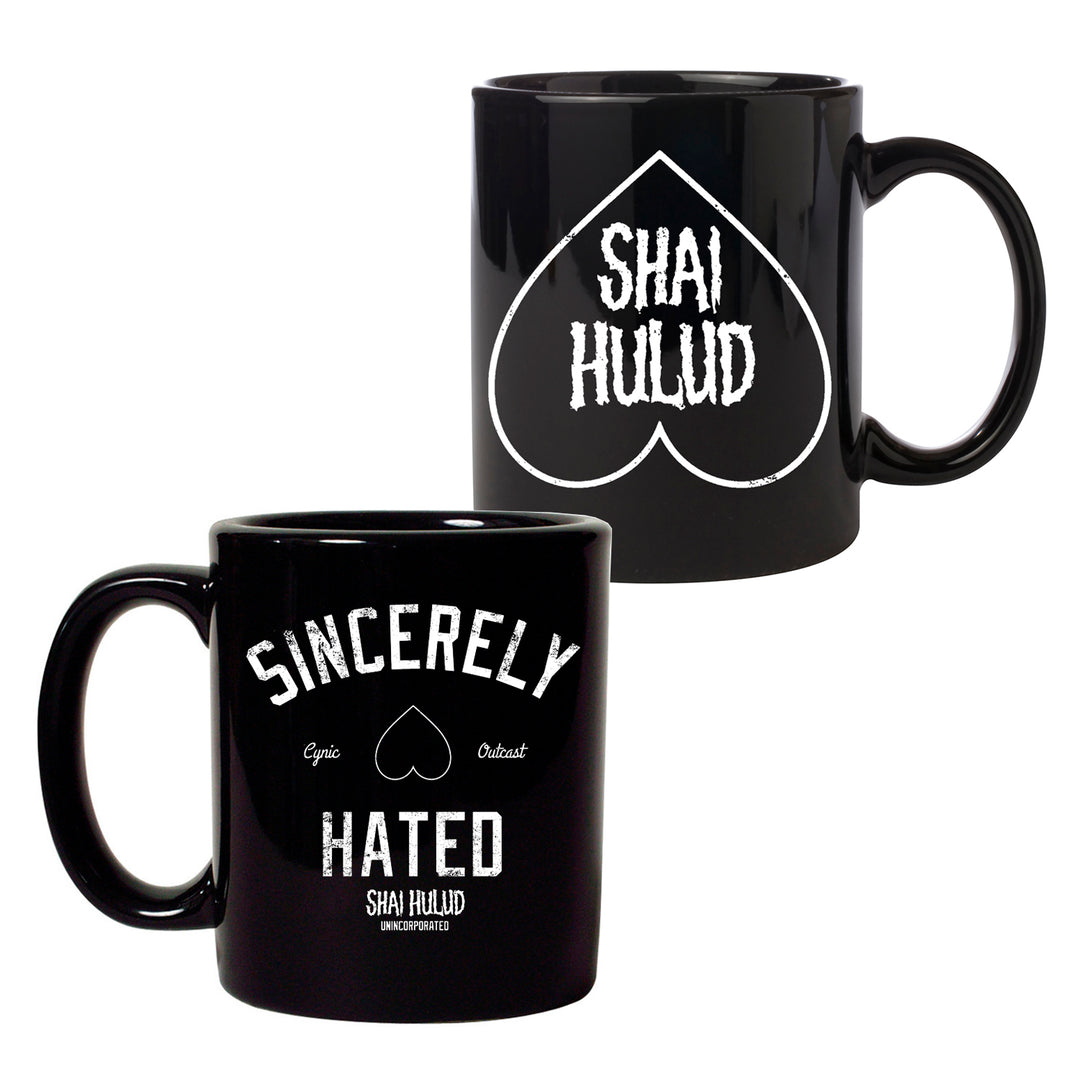 Two Shai Hulud Black Coffee Mugs are pictured—one side shows a heart with SHAI HULUD inside, while the other reads Sincerely Hated, accented by a small heart plus the words Cynic and Outcast.