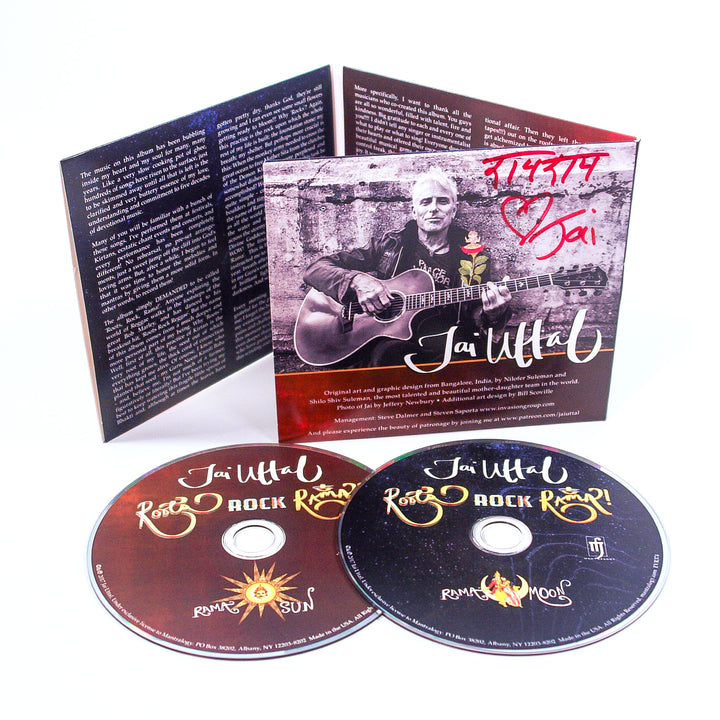 Jai Uttal CD set with two discs labeled Roots, Rock, Rama! (Sun and Moon editions) and an open booklet showing a man with a guitar, autograph, and R.A.S.A. text.