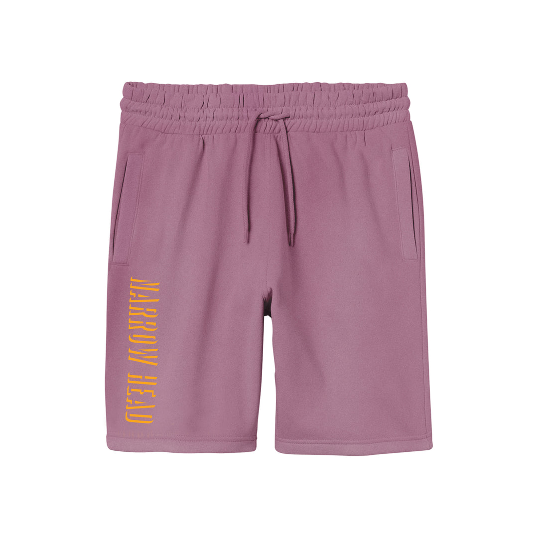 Narrow Head light purple pigment-dyed fleece shorts feature an elastic waistband, drawstring, side pockets, and NARROW HEAD printed vertically in yellow on the left leg for a relaxed fit.