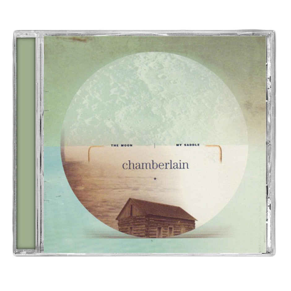 Chamberlain CD cover for The Moon My Saddle features a circular moon graphic, faded seascape with distant stars, a small wooden cabin below, all in muted green and beige tones.