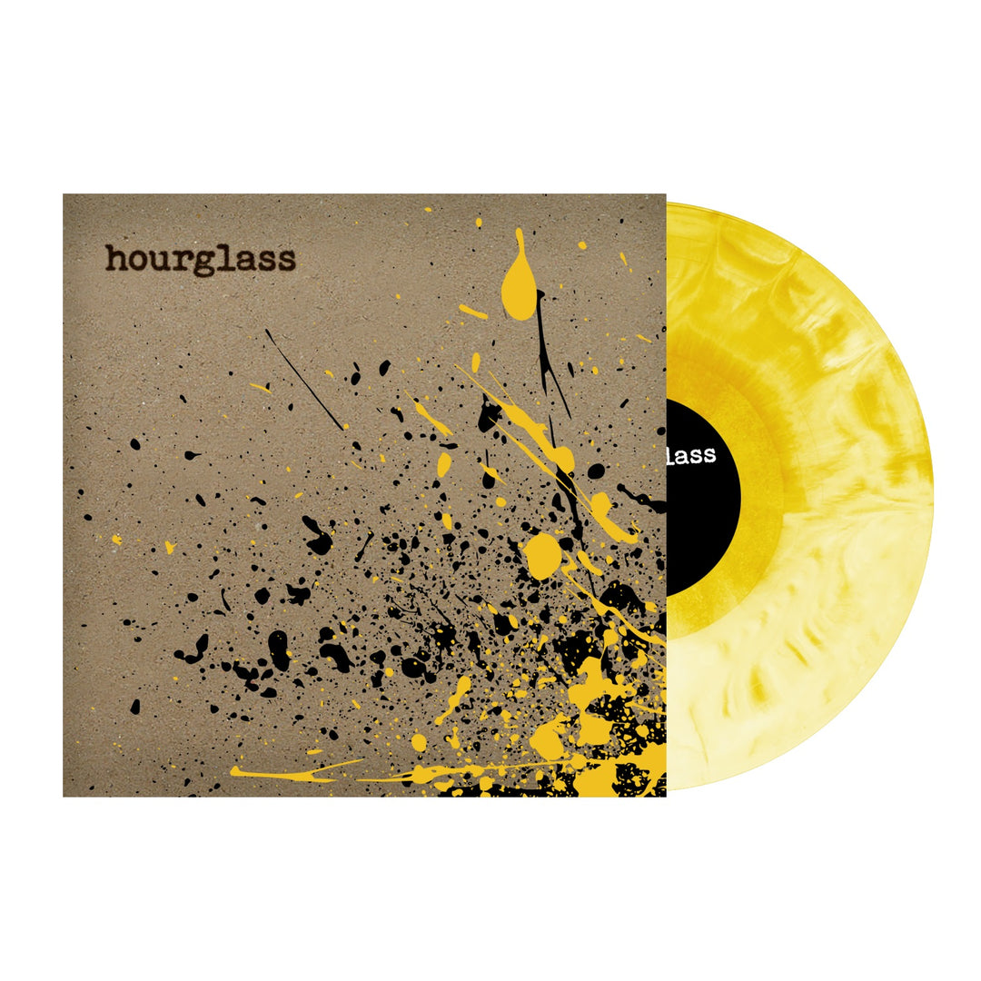 A marbled yellow limited edition vinyl by Hourglass peeks from its brown sleeve, “hourglass” in typewriter font above splattered black and yellow paint, with a black label promising something special inside.