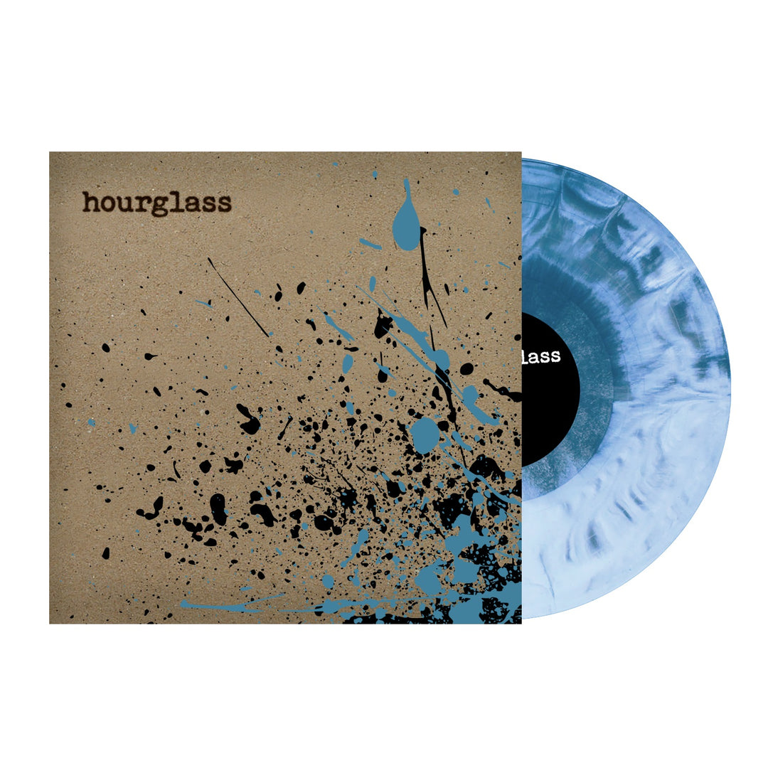 A limited edition Hourglass vinyl record with a gray and white marbled design is partially out of its tan cover, which features black and blue paint splatters and hourglass printed in brown.