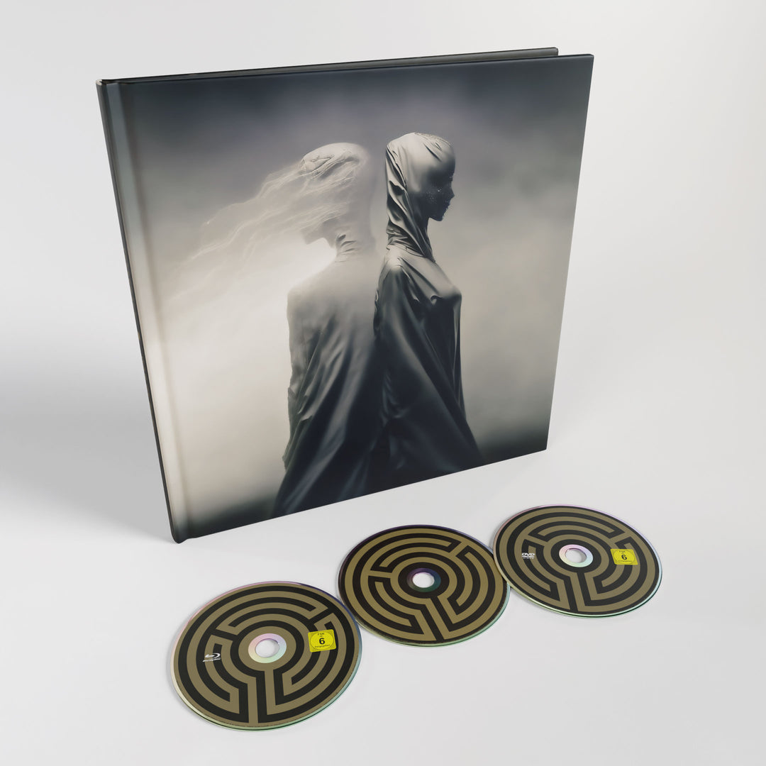A box set from Tesseract for War of Being, showcasing a cover with two hooded figures in mist and three CDs with black and gold maze art—an essential item for fans of The Strangeland era.
