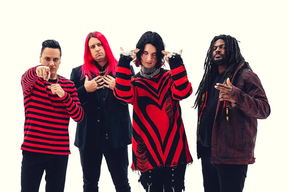 Four people pose against a white background, wearing edgy, dark clothing with red accents. The person in front wears a red and black heart-patterned sweater, and others display unique hairstyles and expressive gestures.