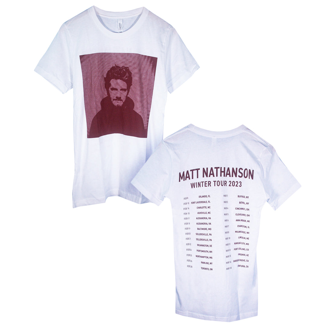 White Matt Nathanson shirt featuring a monochrome bearded man photo on the front. The back lists WINTER TOUR 2023 cities and dates—ideal for fans of music merch and lasting memories.