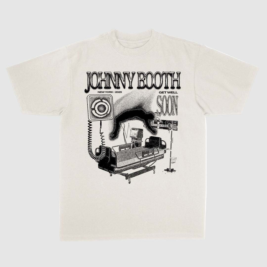 Johnny Booth white t-shirt by Comfort Colors features a black graphic of a hospital bed with medical equipment. Text reads JOHNNY BOOTH, NEW YORK - 2023, and GET WELL SOON—a standout among printed garments.