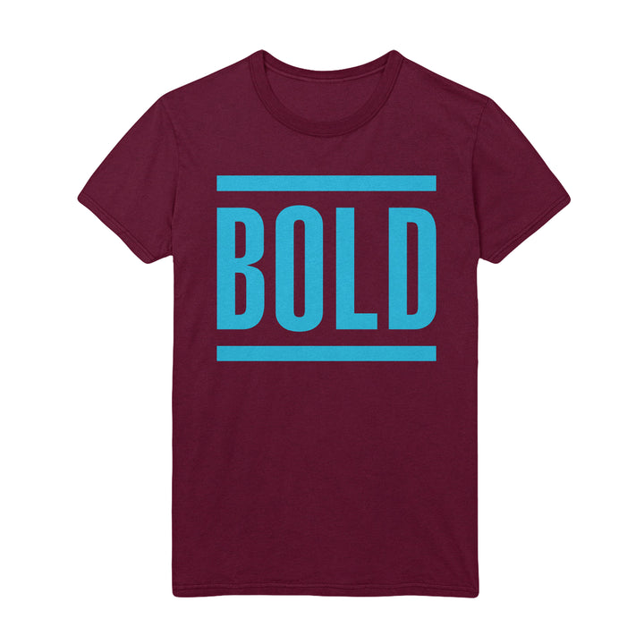 A maroon t-shirt by Bold featuring the brand’s name in large, blue capital letters, framed by two horizontal blue lines above and below.