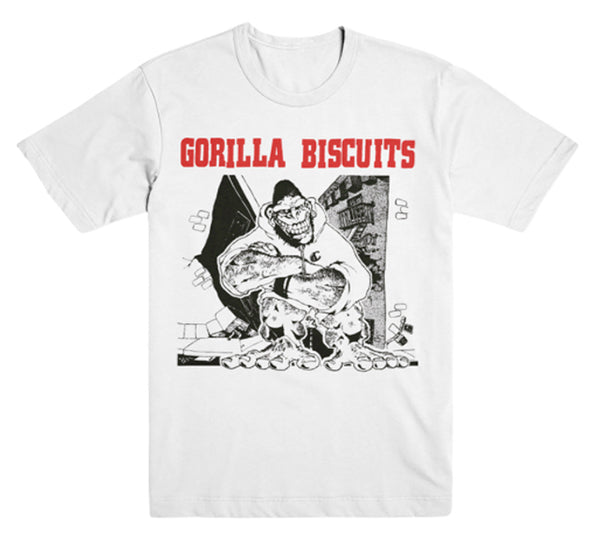 White Gorilla Biscuits Heavy Cotton T-shirt with bold red "Gorilla Biscuits" text above a black-and-white cartoon of a muscular, smiling gorilla on an urban line art background.
