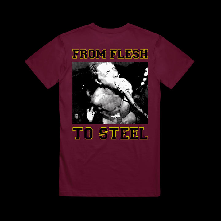 A maroon Shai Hulud Comfort Colors shirt featuring a black-and-white photo of a muscular singer at a mic, with “FROM FLESH TO STEEL” boldly printed above and below the image for standout style.