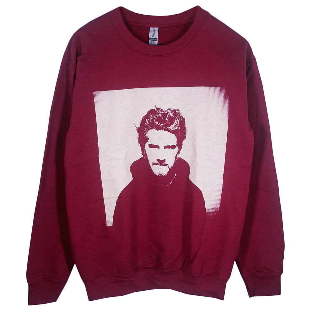 A maroon Matt Nathanson crewneck sweatshirt with a large, monochrome graphic of a bearded man with tousled hair centered on the front.