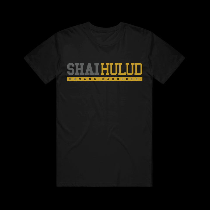 Black Comfort Colors t-shirt by Shai Hulud, with SHAI HULUD in bold gray and yellow across the chest and HUMANE HARDCORE in small yellow text inside a box below—a standout printed garment.