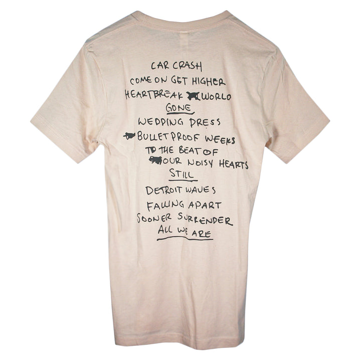 A beige Matt Nathanson t-shirt with handwritten-style black text listing song titles—CAR CRASH, WEDDING DRESS, ALL WE ARE—on the back and playful scribbled-out words for a unique printed tee look.
