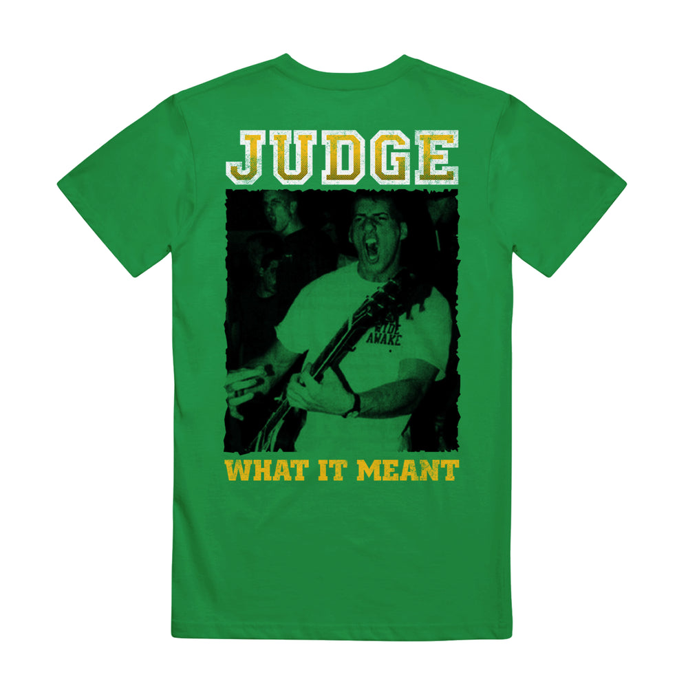 Green t-shirt by Judge, made from heavy cotton, showcases a black-and-white photo of a person playing guitar with bold yellow "JUDGE" above and "WHAT IT MEANT" below.