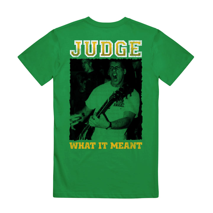 Green t-shirt by Judge, made from heavy cotton, showcases a black-and-white photo of a person playing guitar with bold yellow "JUDGE" above and "WHAT IT MEANT" below.