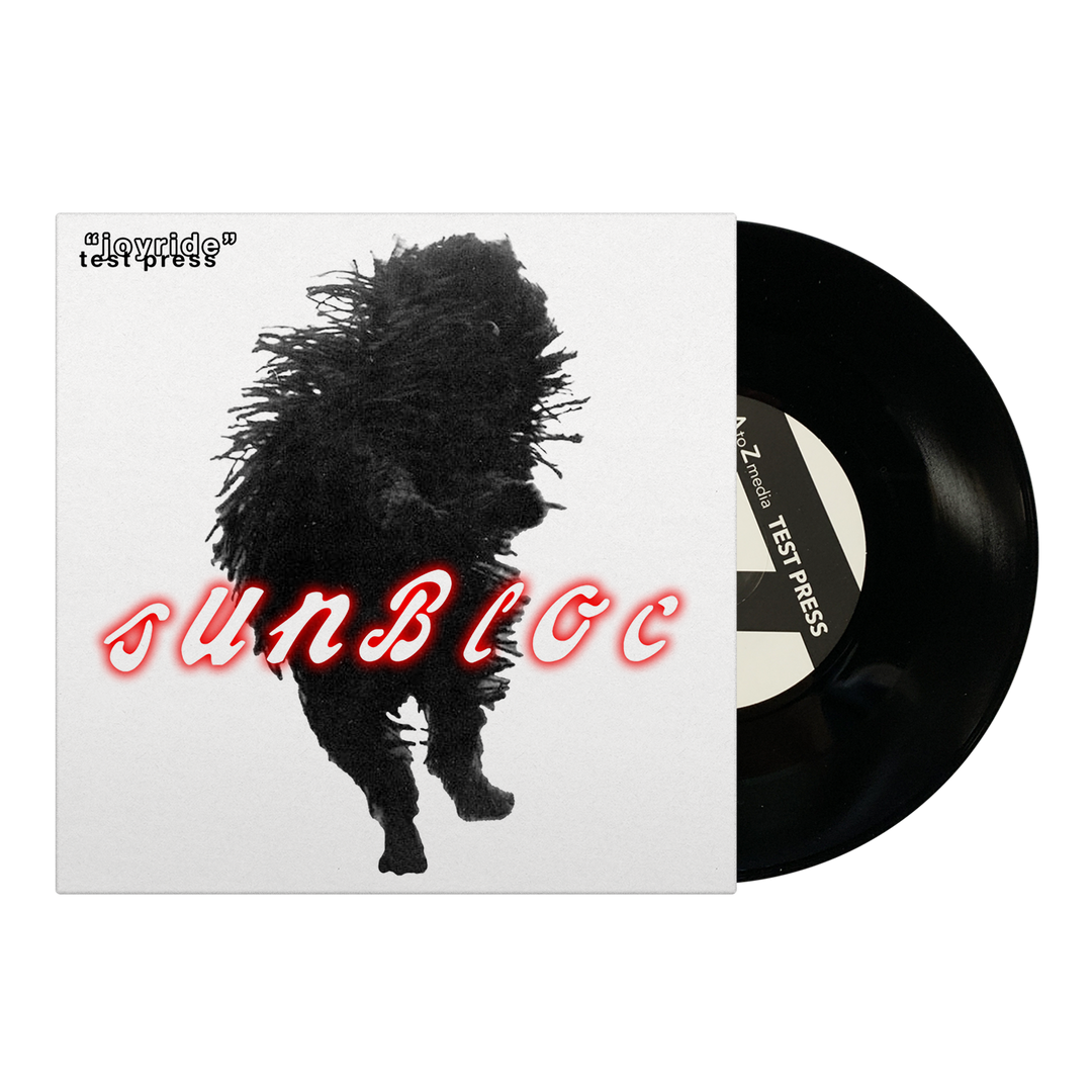 Square album cover for Sunbloc’s Joyride EP features a shaggy, shadowy figure at the center, "Sunbloc" in bold red cursive, and a black vinyl record labeled "testpress," evoking alternative music vibes.