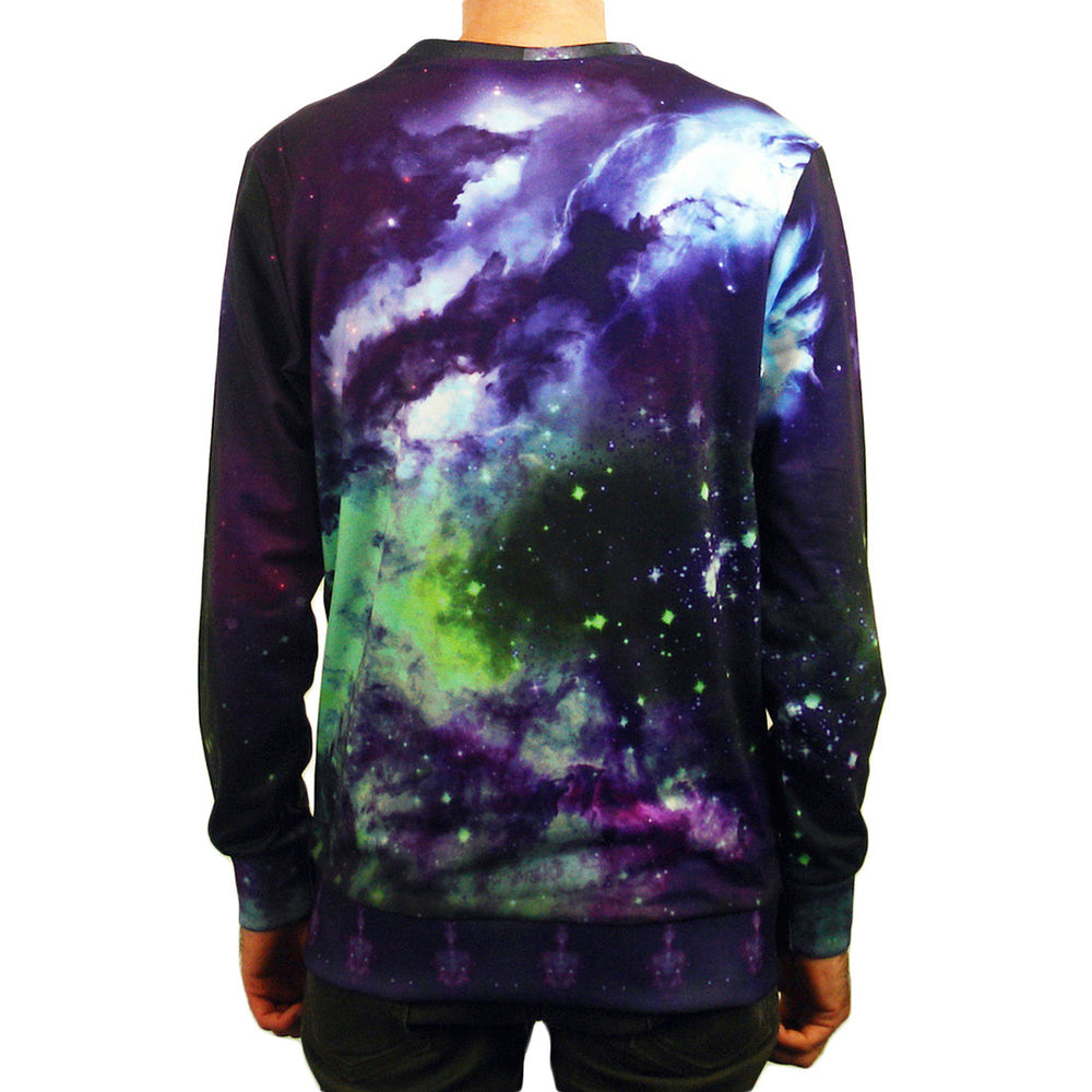 A person faces away, displaying the back of a Stay Sick Clothing long-sleeved sweatshirt with a vibrant outer space sublimation print against a white background.