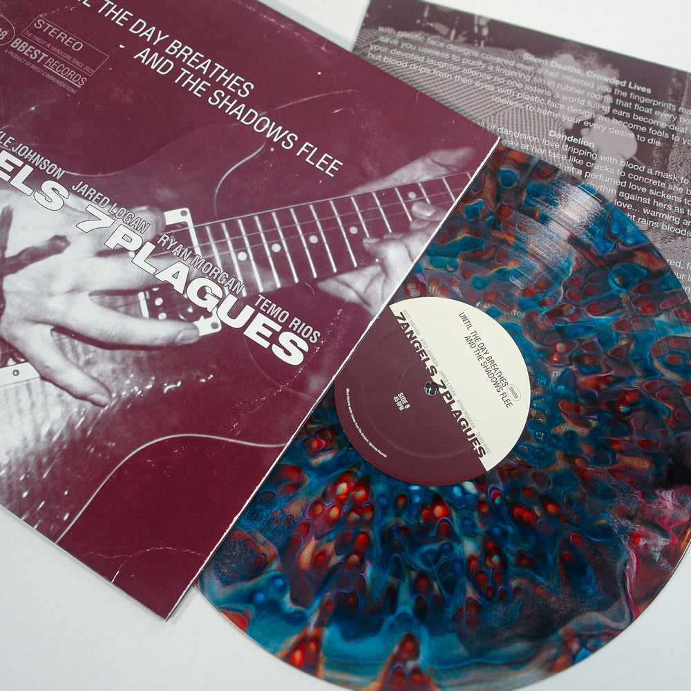 A colorful marbled vinyl record partially pulled from its sleeve, which features a close-up of guitar playing and white text listing band members and the Deluxe album title: 7 Angels 7 Plagues—Until The Day Breathes and the Shadows Flee.