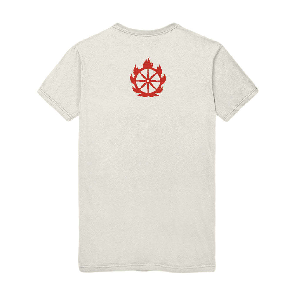 A plain, light-colored Shelter Natural T-Shirt shown from the back, featuring a red graphic of a wheel inside a flame near the upper center.
