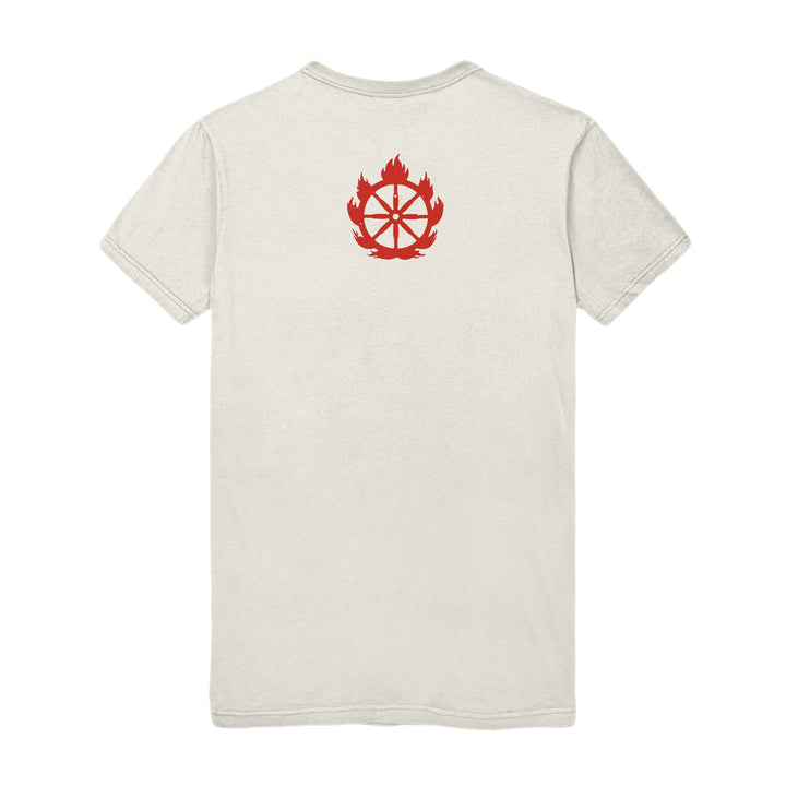 A plain, light-colored Shelter Natural T-Shirt shown from the back, featuring a red graphic of a wheel inside a flame near the upper center.