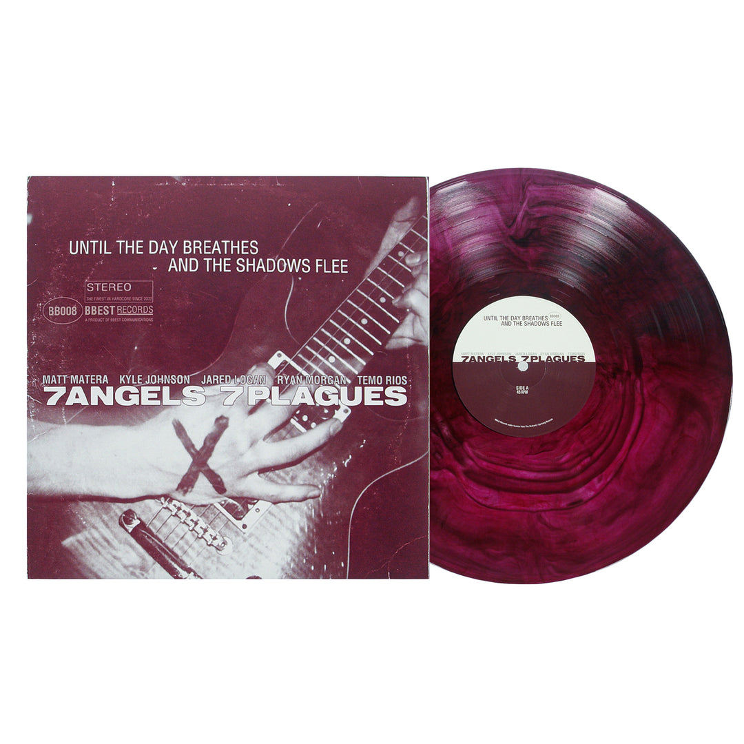 A marbled pink and purple vinyl record from 7 Angels 7 Plagues sits next to its album cover, featuring hands playing a guitar with a red X and the text "Until The Day Breathes, Shadows Flee.