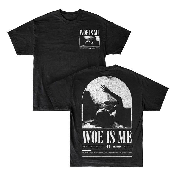 Woe Is Me black T-shirt featuring Woe Is Me text and a grayscale image of a person raising an arm on both sides. Back includes DAYBREAK | 2025 | LP3 and graphics—ideal for fans awaiting LP3 or collecting black vinyl editions.