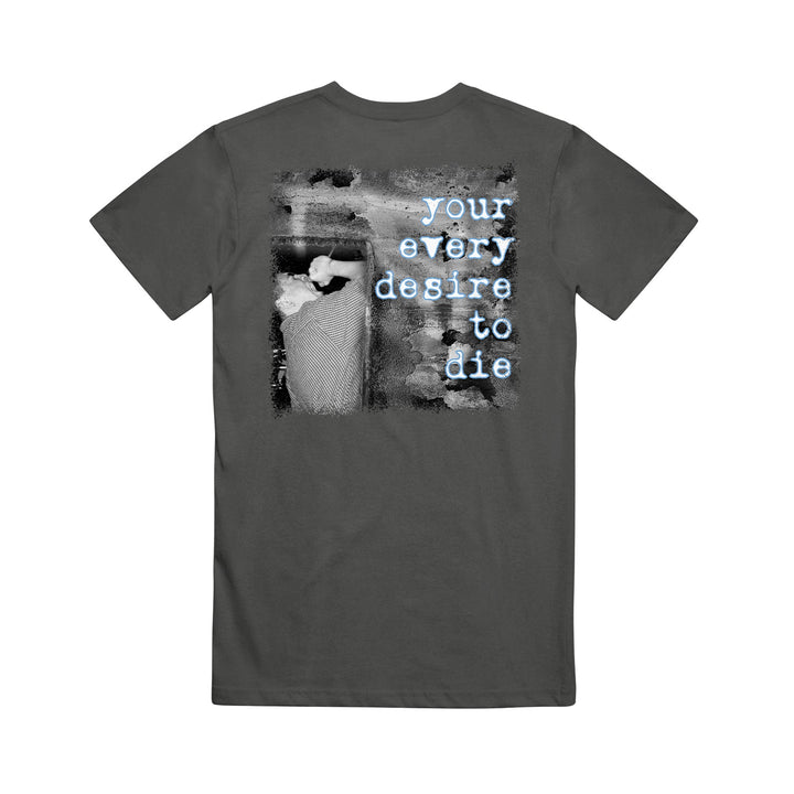 A dark gray 7 Angels 7 Plagues Comfort Colors tee with a black-and-white image of a person lying down, and “your every desire to die” in light blue typewriter-style font over the back image.