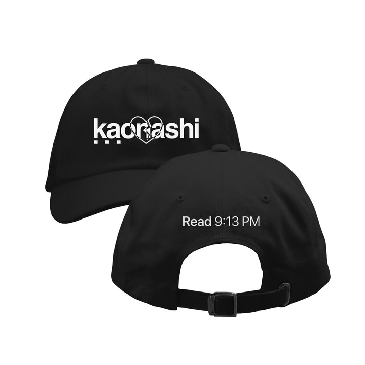 A black Kaonashi dad hat is shown from the front and back. The front has "Kaonashi" in bold white text with a broken heart graphic, while the back features "Read 9:13 PM" embroidered above the adjustable strap—perfect for any casual look.