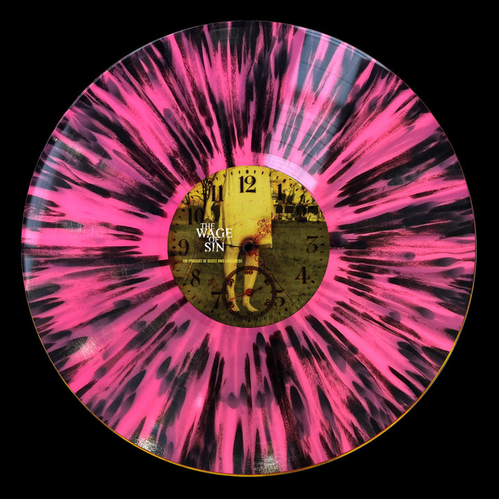 A limited edition The Wage Of Sin vinyl with a black and bright pink splatter design. The center label features a vintage clock face, sepia "Wage War Manic" text, and a figure—ideal for fans and collectors.