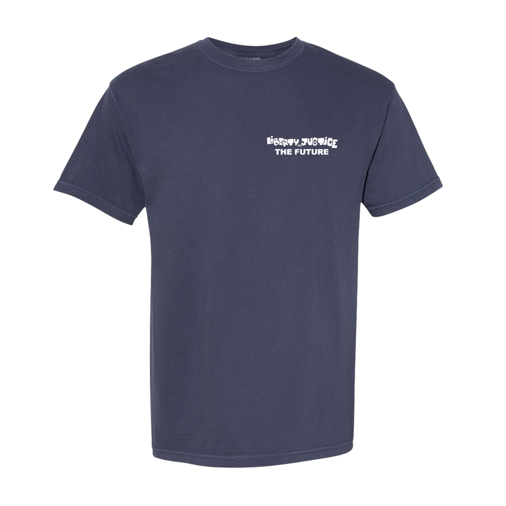 A plain dark blue Liberty & Justice Comfort Colors t-shirt features bold white text reading "HUMAN JUSTICE THE FUTURE" on the left chest in a stylized font, displayed against a plain white background.