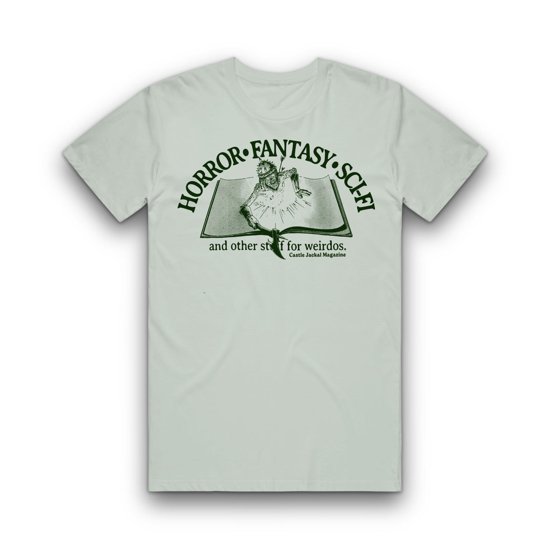 Light gray Comfort Colors tee from Castle Jackal featuring a person reading on a bed, with “HORROR • FANTASY • SCI-FI and other stuff for weirdos. Castle Media Magazine” in green. Available now for pre-order.