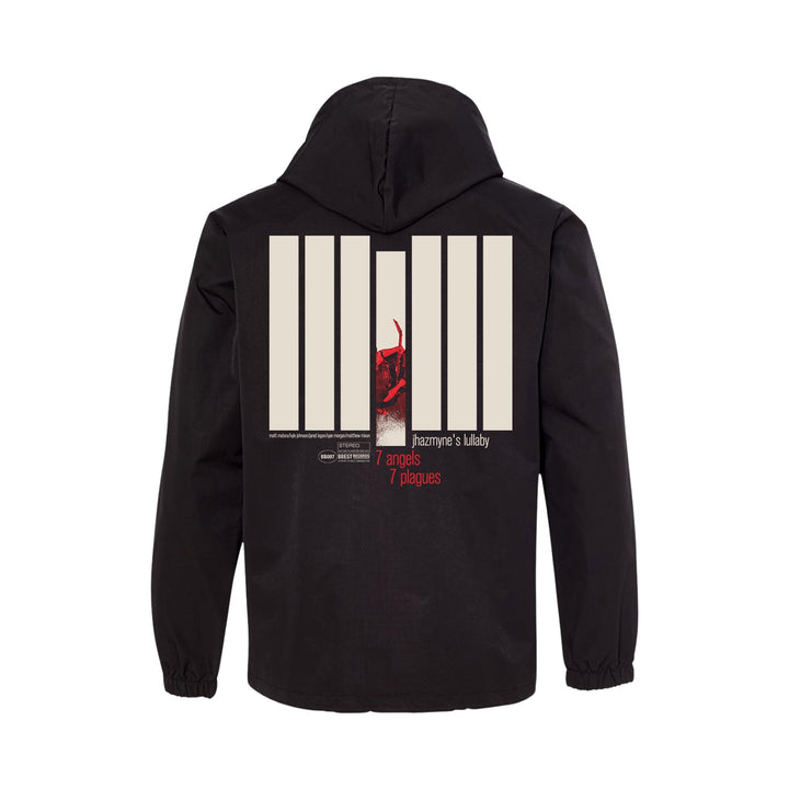 Black water-resistant windbreaker by 7 Angels 7 Plagues with a large back graphic: seven beige vertical bars, red-toned abstract image, and "7 angels 7 plagues" plus "Jazzyanne’s lullaby" in white and red. Direct to film transfers.