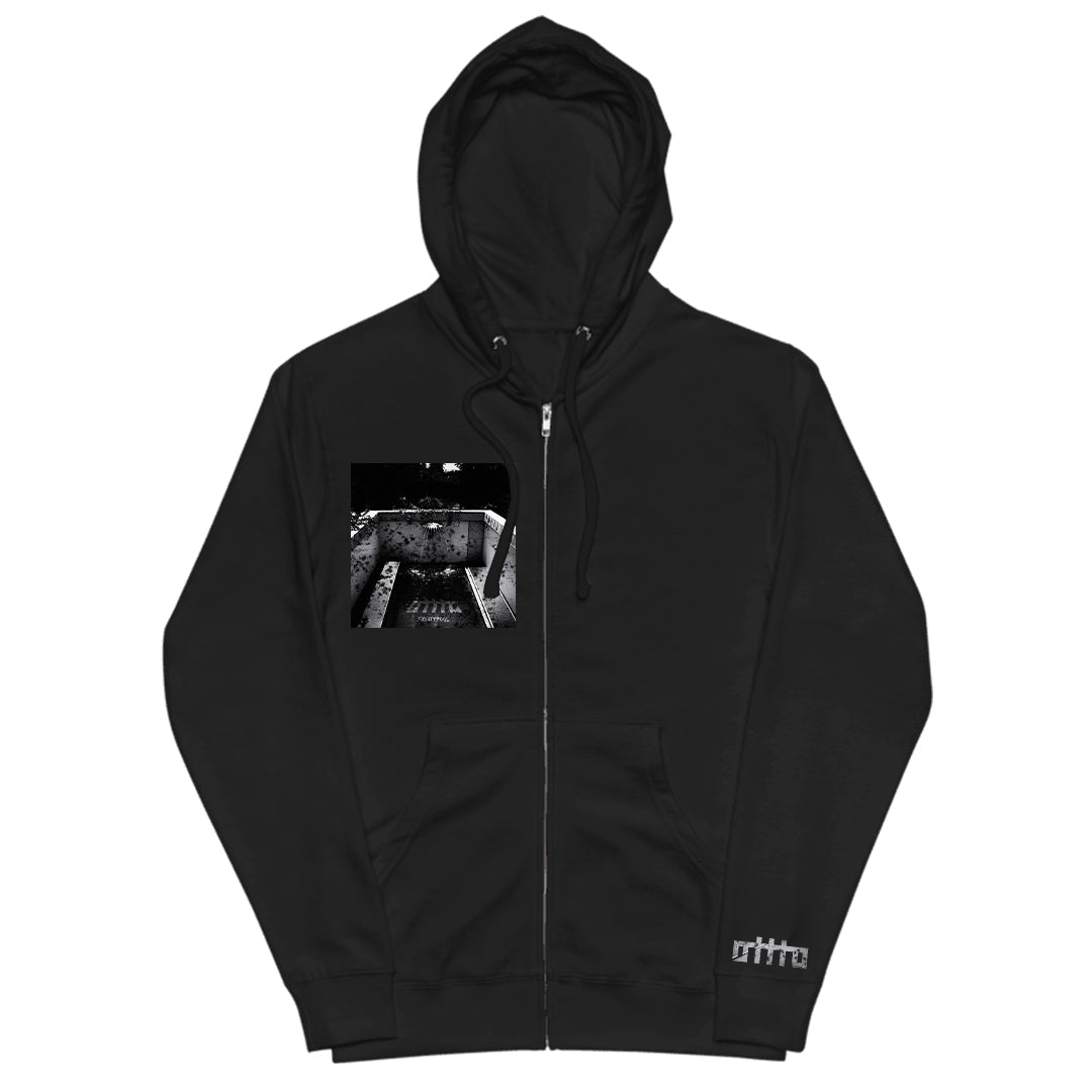 Black zip-up hoodie by OTTTO in premium Gildan Softstyle, featuring a white ortta logo near the hem and a black-and-white industrial print on the chest. Includes front zipper and drawstring hood. Available now for presale.