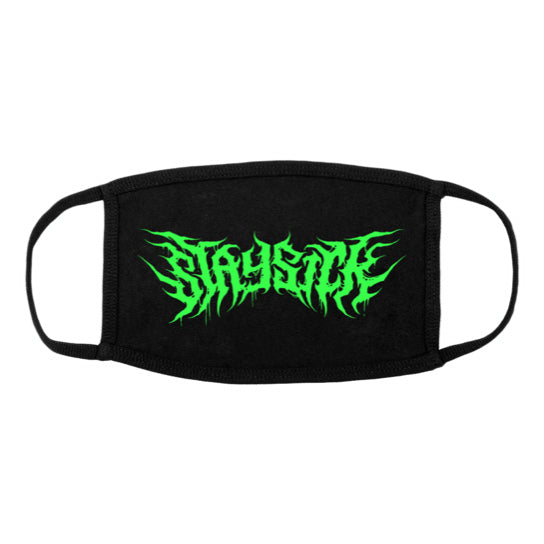 A black face mask from Stay Sick Clothing, featuring a green, flame-like death metal STAY SICK logo in the center and ear loops. Hand-wash recommended for best care.