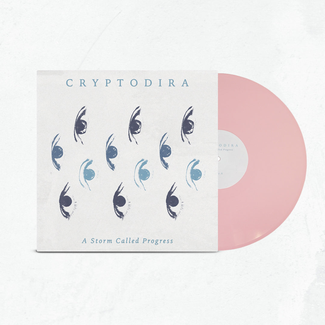 A limited edition light pink vinyl slides out of a cover featuring blue and black stylized eye art. The cover displays Cryptodira at the top and A Storm Called Progress at the bottom.