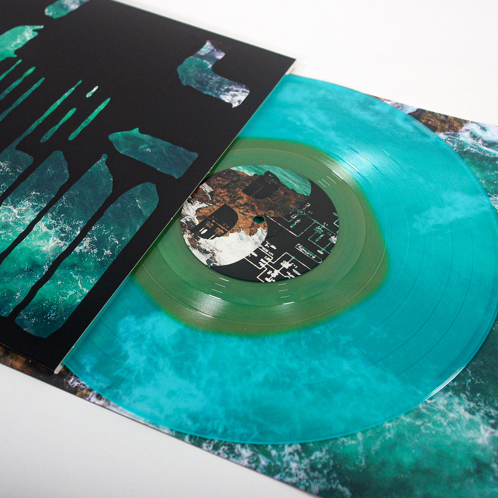 A turquoise and green marbled Joshua post hardcore vinyl partially slid from its sleeve, featuring abstract ocean and land artwork with teal and black accents—a perfect collectible for emo music fans.