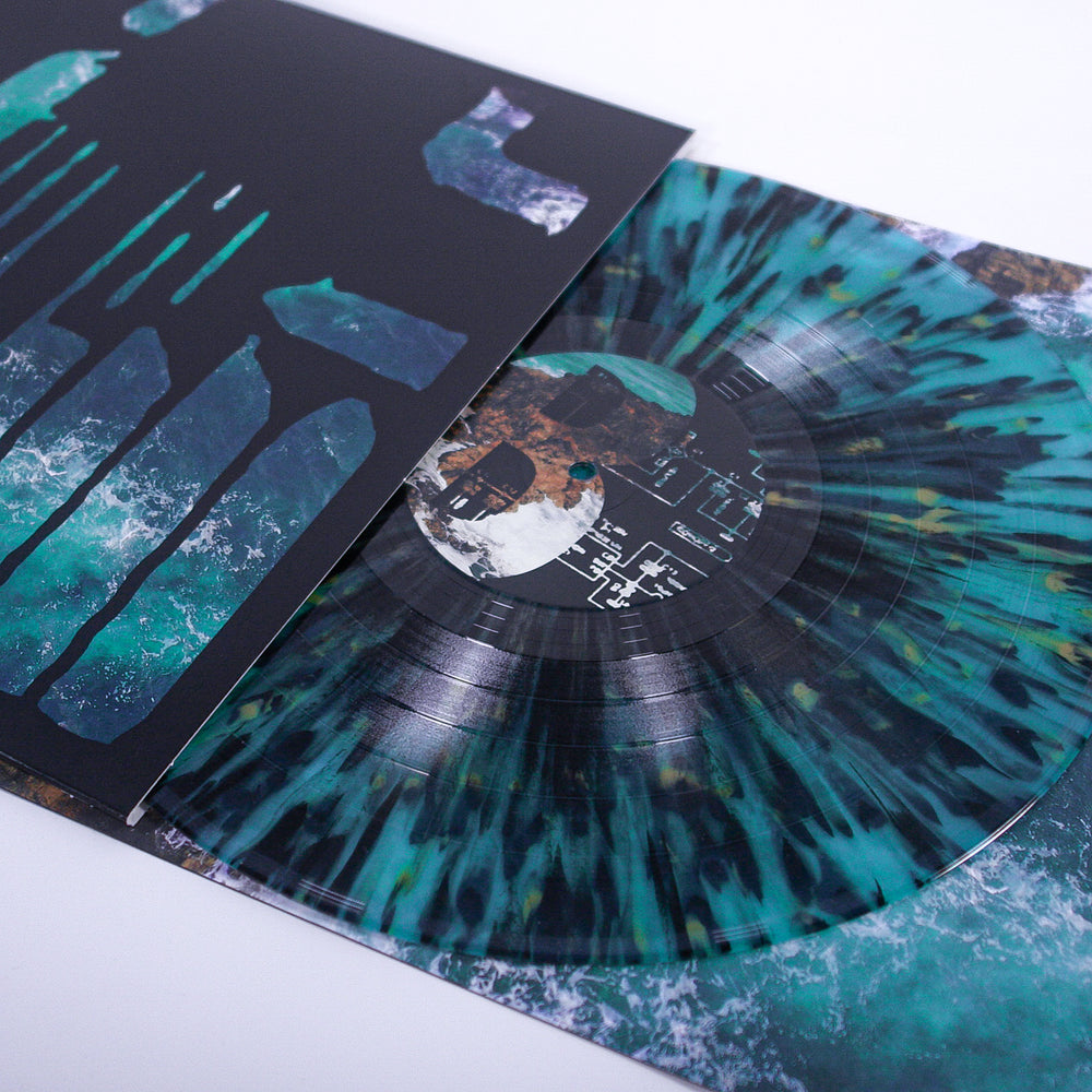 A close-up of a Joshua teal and black marbled post-hardcore vinyl, partially pulled from its sleeve with abstract blue, green, and black art on a white background—ideal for emo music reissue fans.