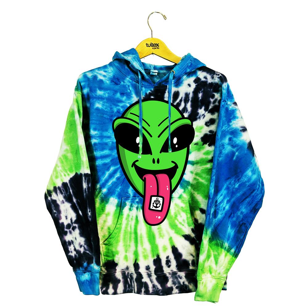 The Stay Sick Clothing Alien Trip Swirl hoodie features blue, green, and black custom dye, a large green alien face with its pink tongue out (with a small black-and-white drawing) and hangs on a wooden hanger.
