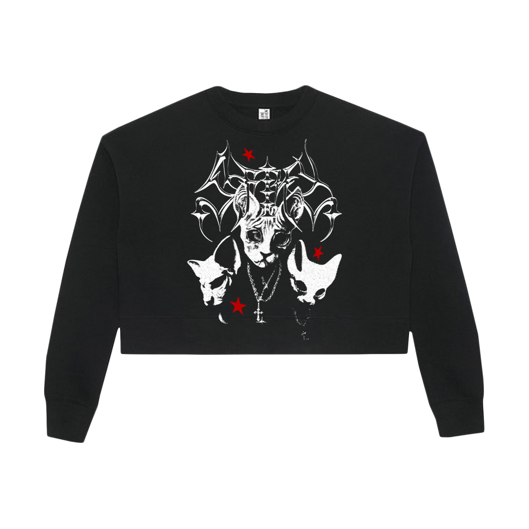 Black cropped sweatshirt with a gothic graphic: a horned, bat-winged creature, two animal heads, three red stars, and a cross necklace on the front. Crafted from soft cotton fleece, this women’s relaxed crop crewneck by Lane Seven delivers both edgy style and everyday comfort.