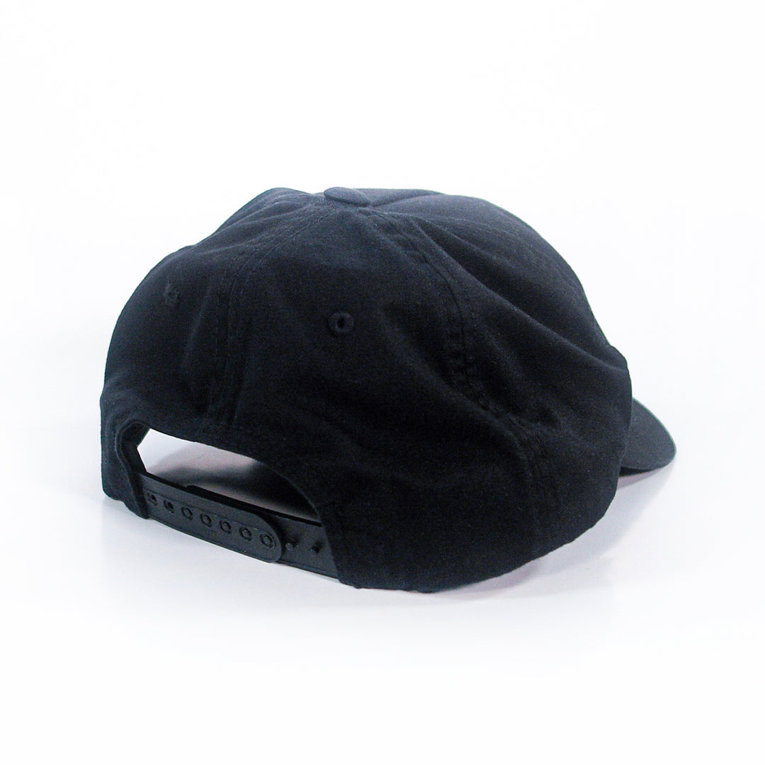 A Castle Jackal black 5-panel snapback baseball cap viewed from the back, showing an adjustable snapback closure against a white background.