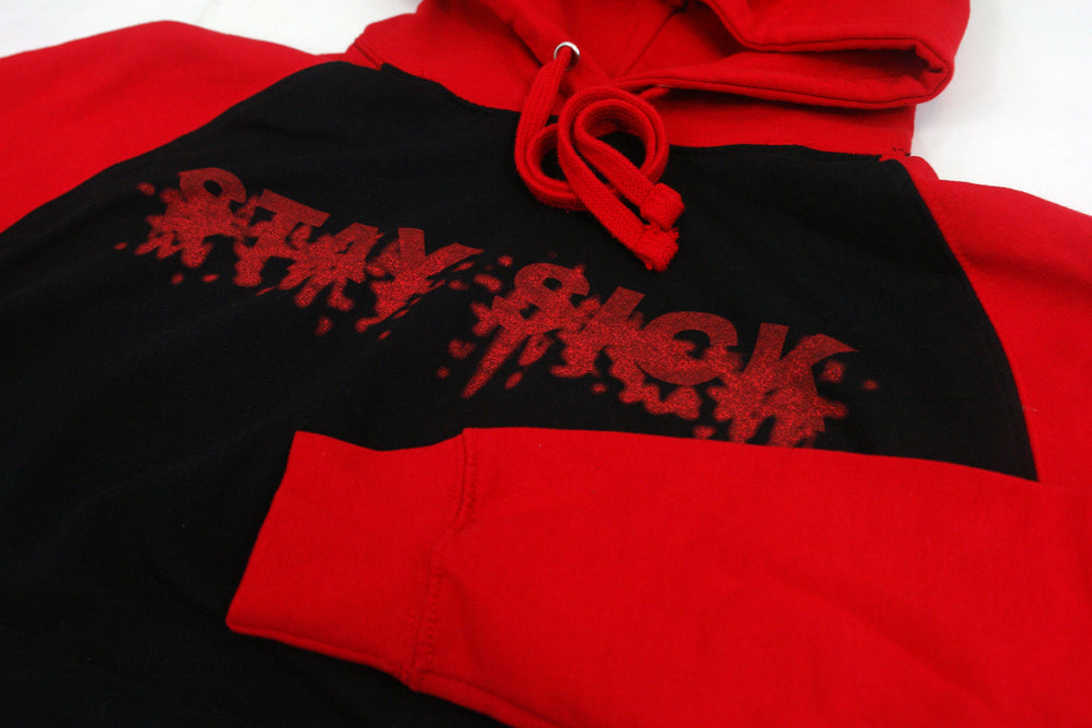 Stay Sick Clothing’s red and black raglan hoodie features bold red sleeves, a black body, and “STAY SICK” in a dripping graffiti font across the chest for standout style.