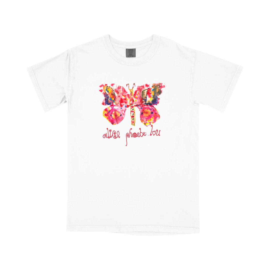 White t-shirt featuring a colorful, abstract butterfly design in pink, orange, and yellow, with cursive text below that reads “alles phoebi lou” in pink. Crafted from soft ring-spun cotton for superior comfort and durability.