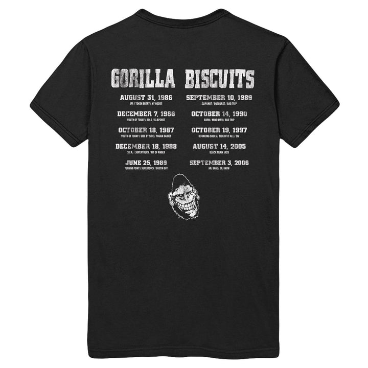 Gorilla Biscuits black Gildan heavy cotton t-shirt featuring the band name in bold white letters, a back print with tour dates, cities, and a white gorilla illustration near the lower back center.