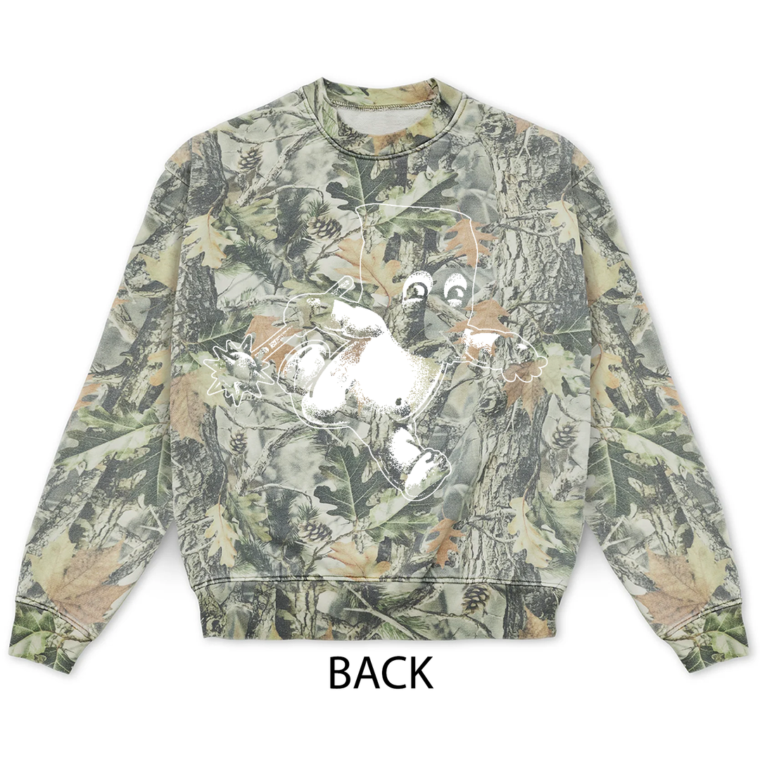 Vintage wood camo crewneck sweatshirt in a tree bark and leaf print, featuring a white graphic of a Jackal Kewpie character on the back.
