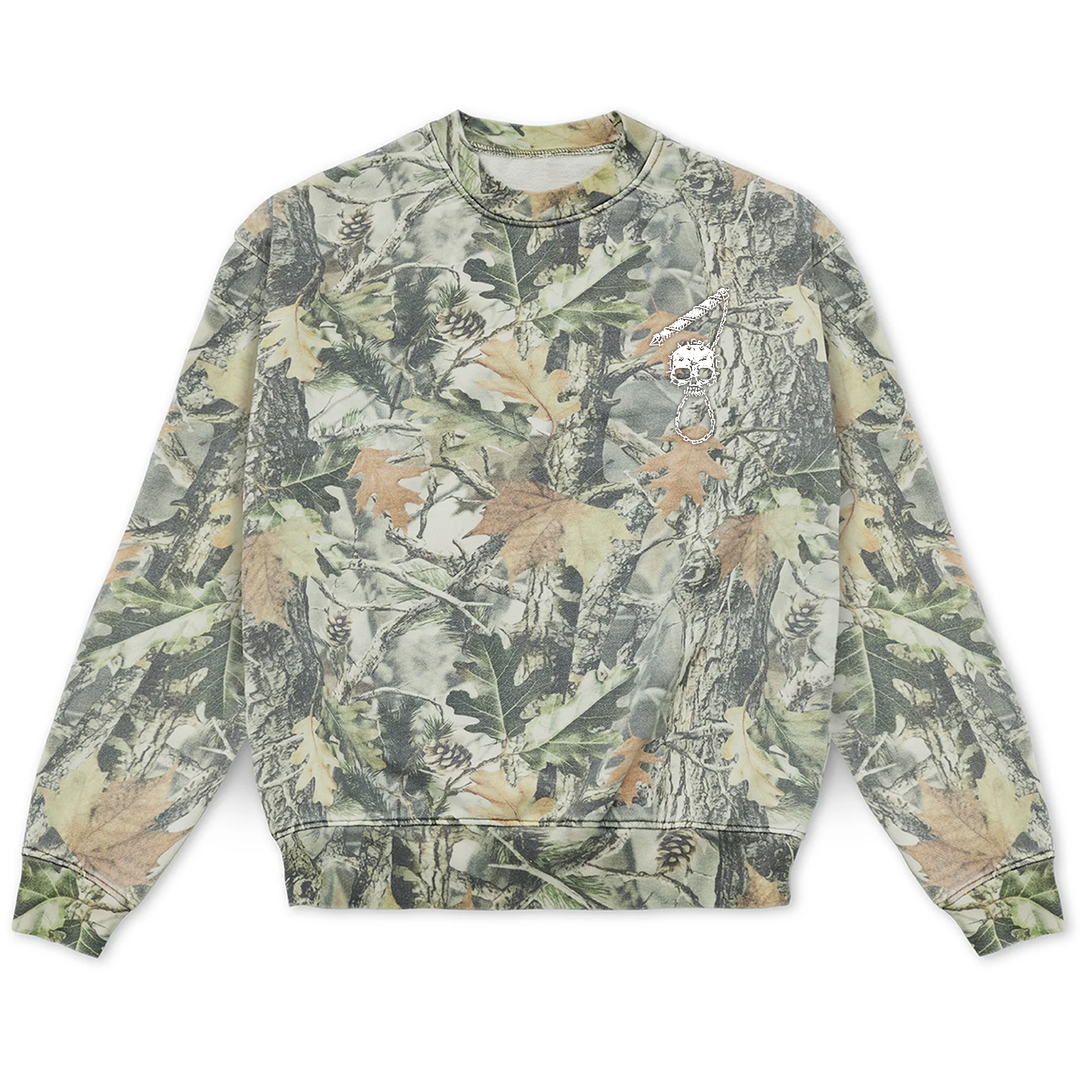 Long-sleeved vintage wood camo sweatshirt featuring a small embroidered skull flail graphic on the upper chest.