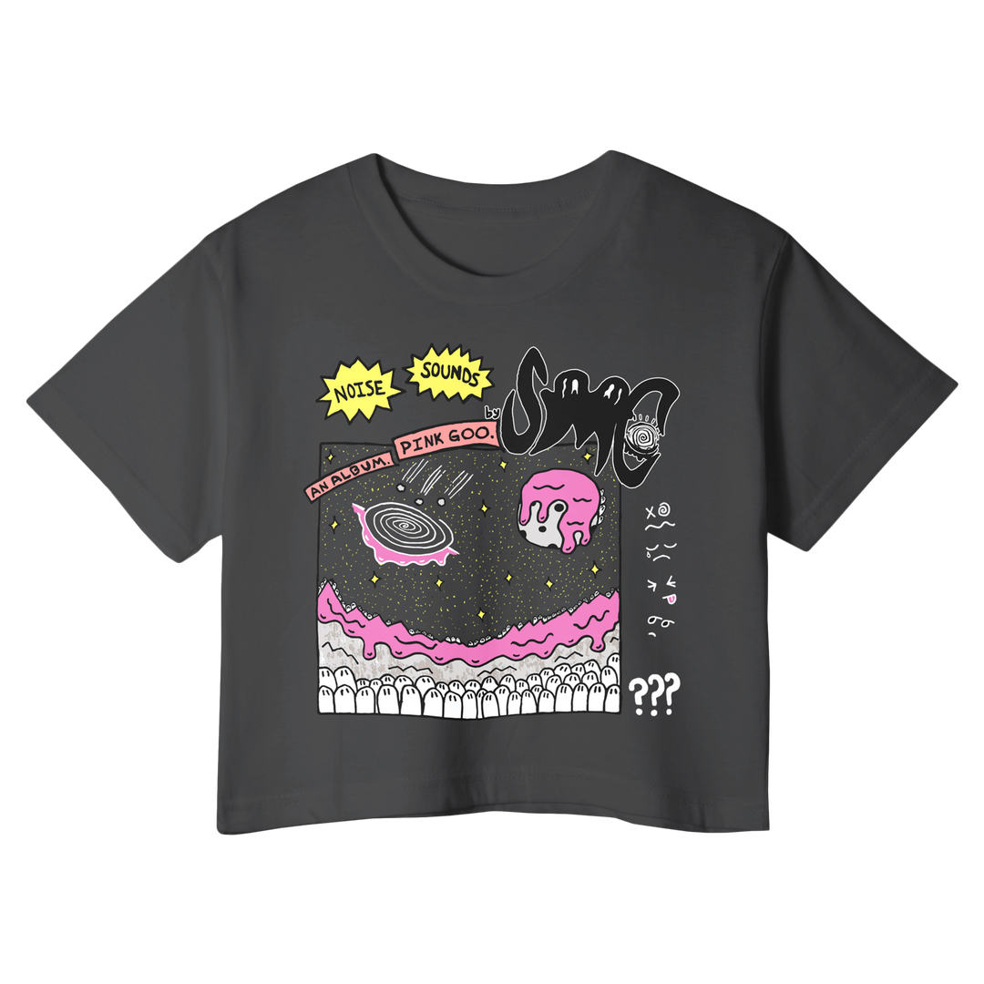 A black crop t-shirt by Strawberry Milk Cult with a vibrant graphic of pink blobs, a galaxy, abstract shapes, and text like NOISE SOUNDS and SAUCE WITH PINK GOO in yellow, red, white, and pink—ideal for Pink Goo style fans.